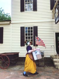 Rear view of woman against building