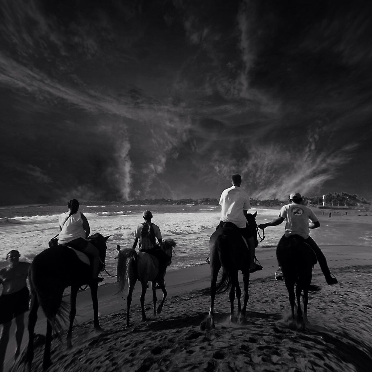 men, lifestyles, leisure activity, beach, sky, person, sand, large group of people, horse, animal themes, domestic animals, working animal, walking, riding, rear view, togetherness, full length, transportation, mixed age range