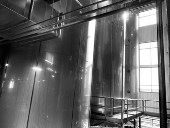 Low angle view of illuminated lights on glass window at night