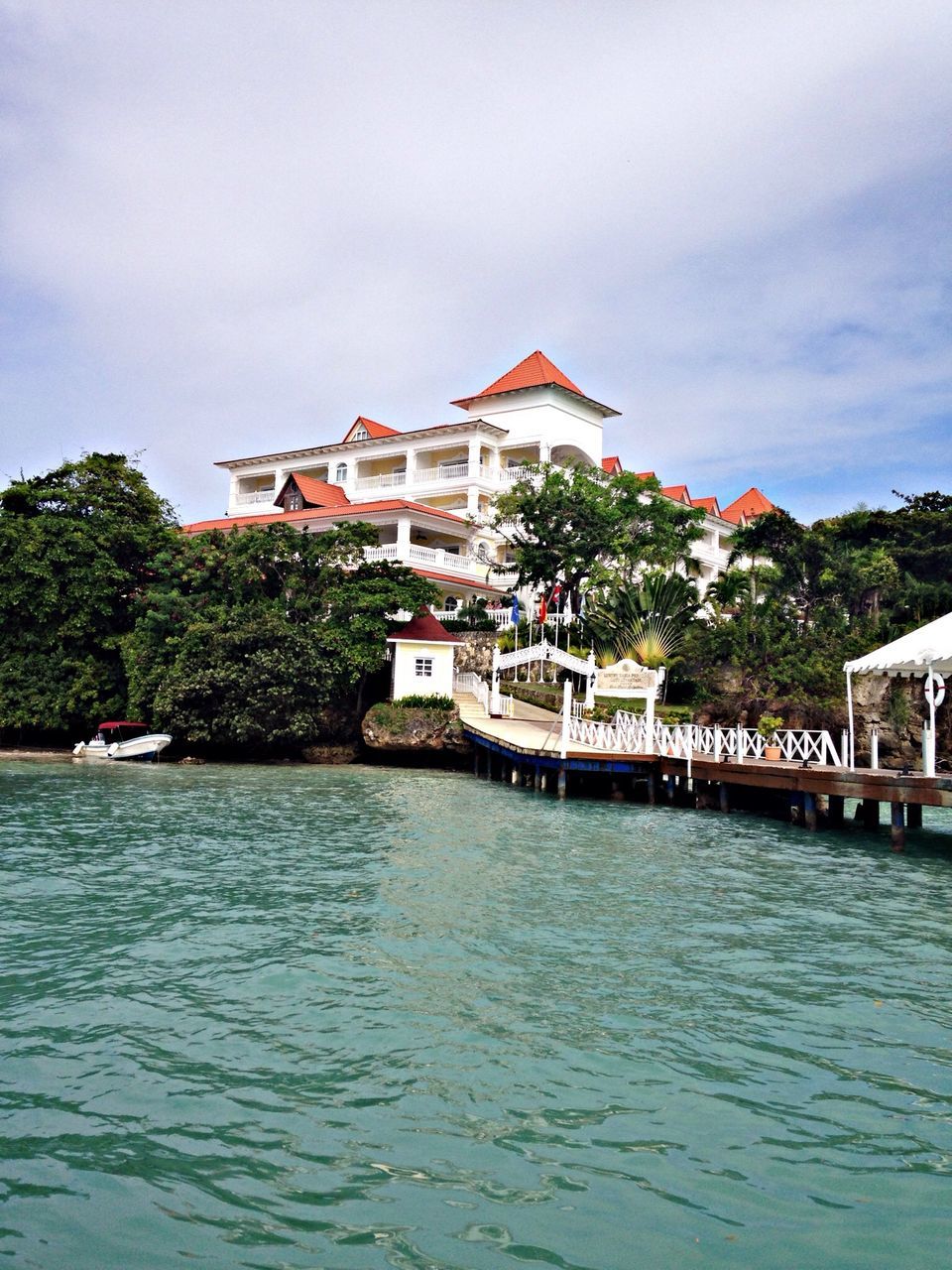 architecture, building exterior, built structure, water, waterfront, sky, house, tree, rippled, residential structure, river, residential building, cloud - sky, lake, cloud, day, town, outdoors, nature, no people