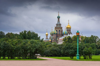 View of trees and building against sky