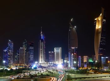 Panoramic view of illuminated buildings against sky at night