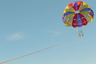 Low angle view of balloons flying in sky