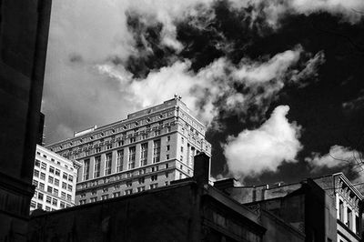 Low angle view of building against cloudy sky