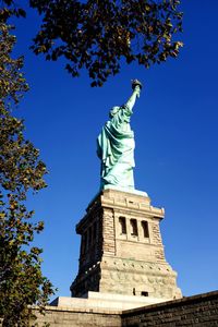 Low angle view of statue against blue sky