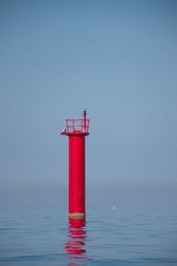 Red lighthouse on the open adriatic sea