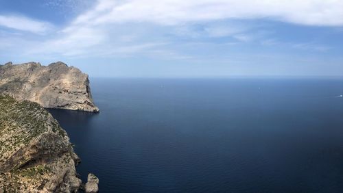 Scenic view of rocks in sea against sky