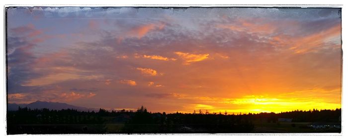 Scenic view of landscape against sky at sunset