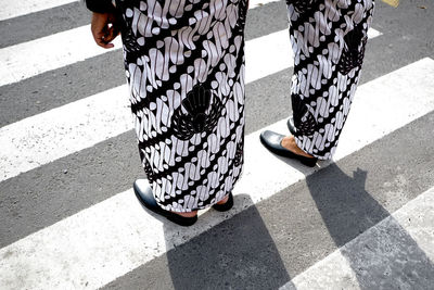 Low section of women standing on street