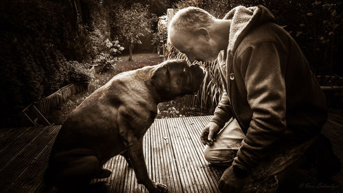 Man with dog in back yard