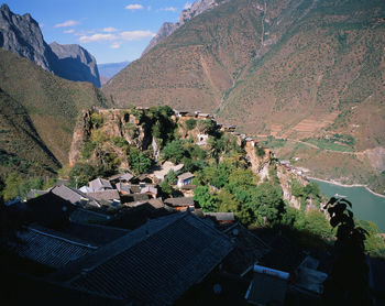 Panoramic view of townscape and mountains against sky