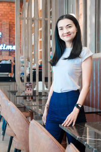 Portrait of a smiling young woman standing outdoors