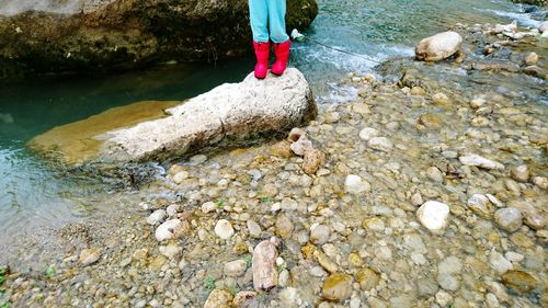 Low section of man standing on rock