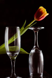 Close-up of wineglass on table against black background