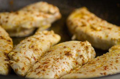 Close-up of chicken meat being cooked on pan