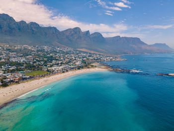 Scenic view of sea and mountains against sky