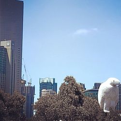 Low angle view of modern building against blue sky