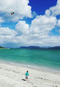 Man on beach against sky