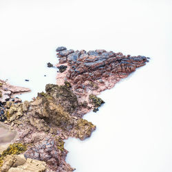 Aerial view of rock formation in lake