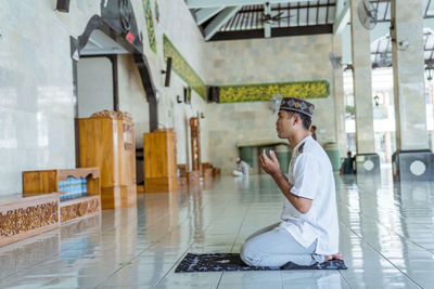 High angle view of man praying in mosque