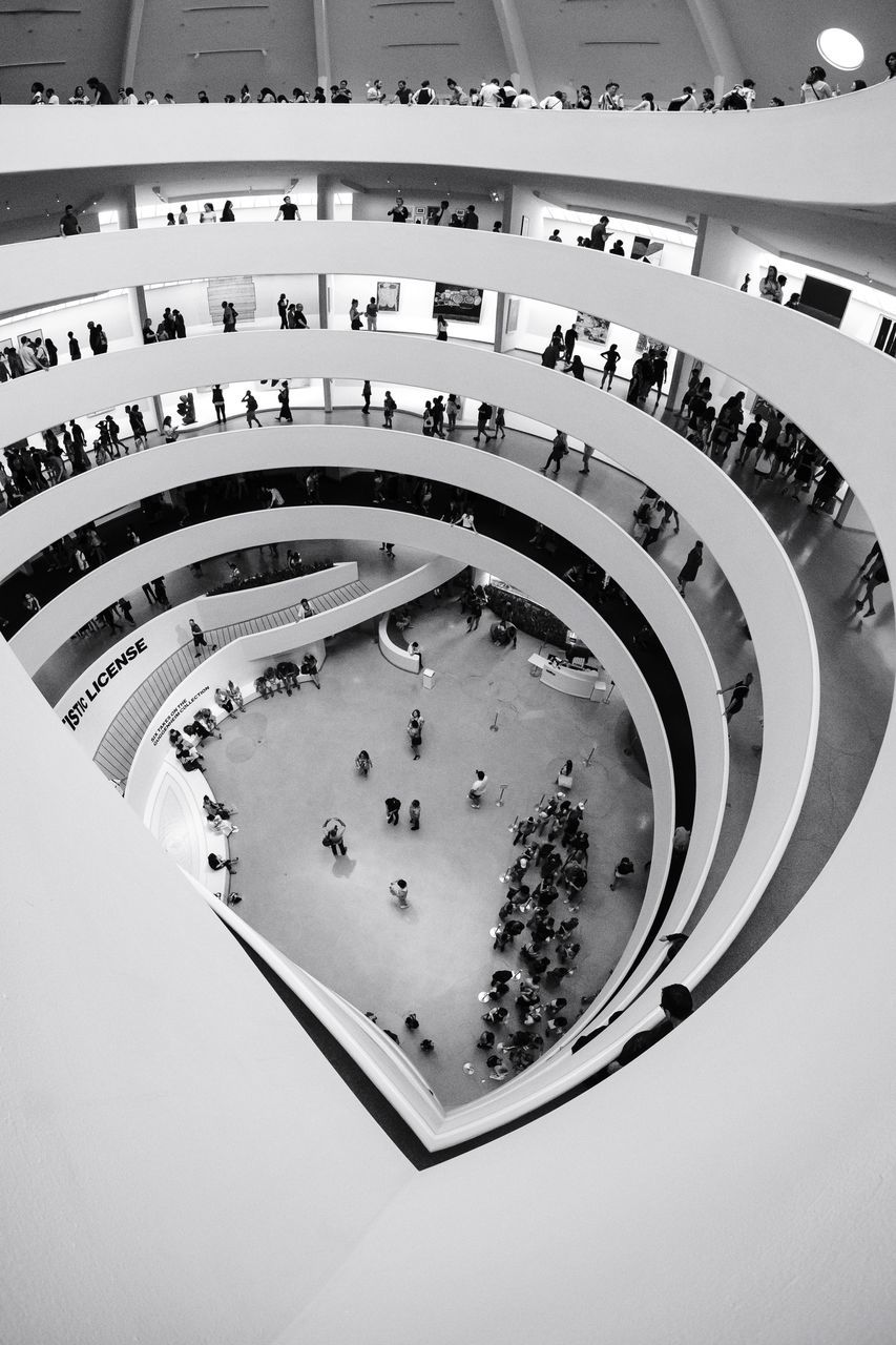 architecture, high angle view, built structure, group of people, large group of people, real people, crowd, incidental people, travel destinations, railing, day, indoors, staircase, tourism, unrecognizable person, steps and staircases, spiral, travel, modern