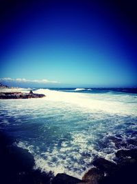 Scenic view of sea against blue sky