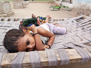 Cute girl lying down on bed at village