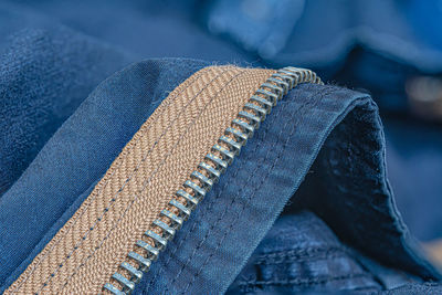Close up shot of a blue textile jeans zipper