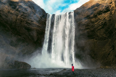 Low angle view of waterfall against sky