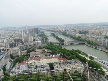 High angle view of river amidst buildings in city against sky