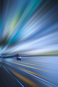 Light trails on road in city at night