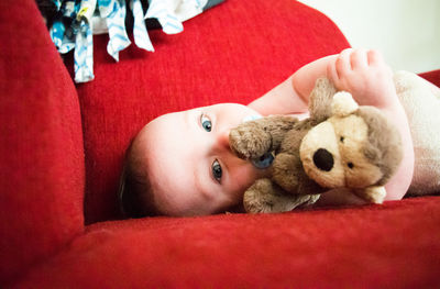 Portrait of cute baby girl with toy at home