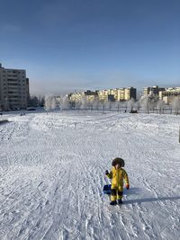 Boy on snow covered land