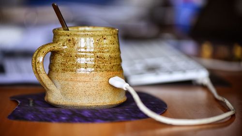 Keyboard cable connected to tea cup on mouse pad