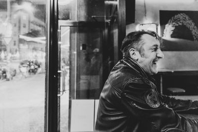 Portrait of man looking through window