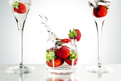 Close-up of fruits in glass against white background