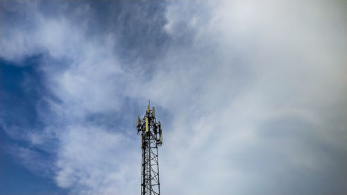 Low angle view of communications tower against sky