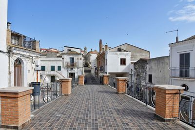 A narrow street between the old houses of grottole, a village in the basilicata region, italy.