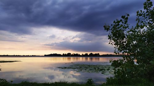 Scenic view of lake against sky during sunset