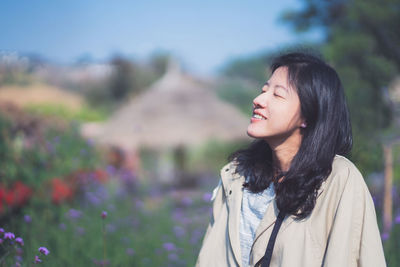 Portrait of a smiling young woman standing outdoors