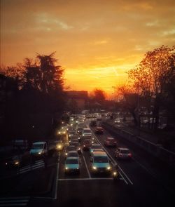 Cars on road at sunset