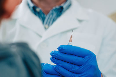 Close-up of doctor giving injection to patient