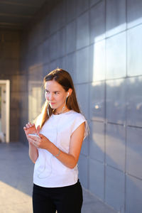 Portrait of young woman using mobile phone