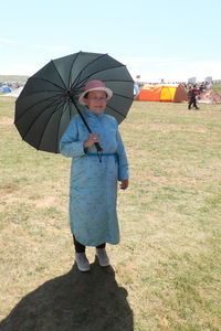 Man with umbrella standing in rain