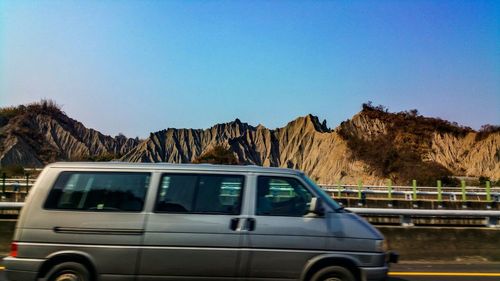 Cars on road against clear sky