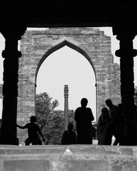 Rear view of people walking in historical building