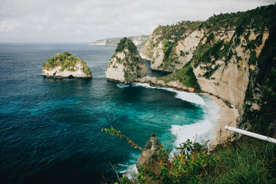 High angle view of rocks by sea against sky