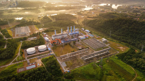 Aerial view of a gas turbine power plant station during sunrise.