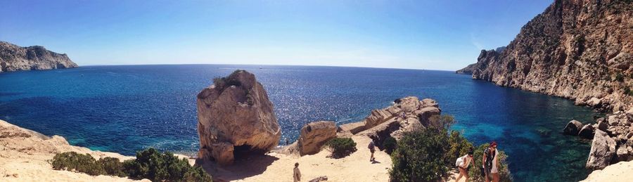 Panoramic view of sea against clear blue sky