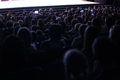 High angle view of crowd sitting in auditorium